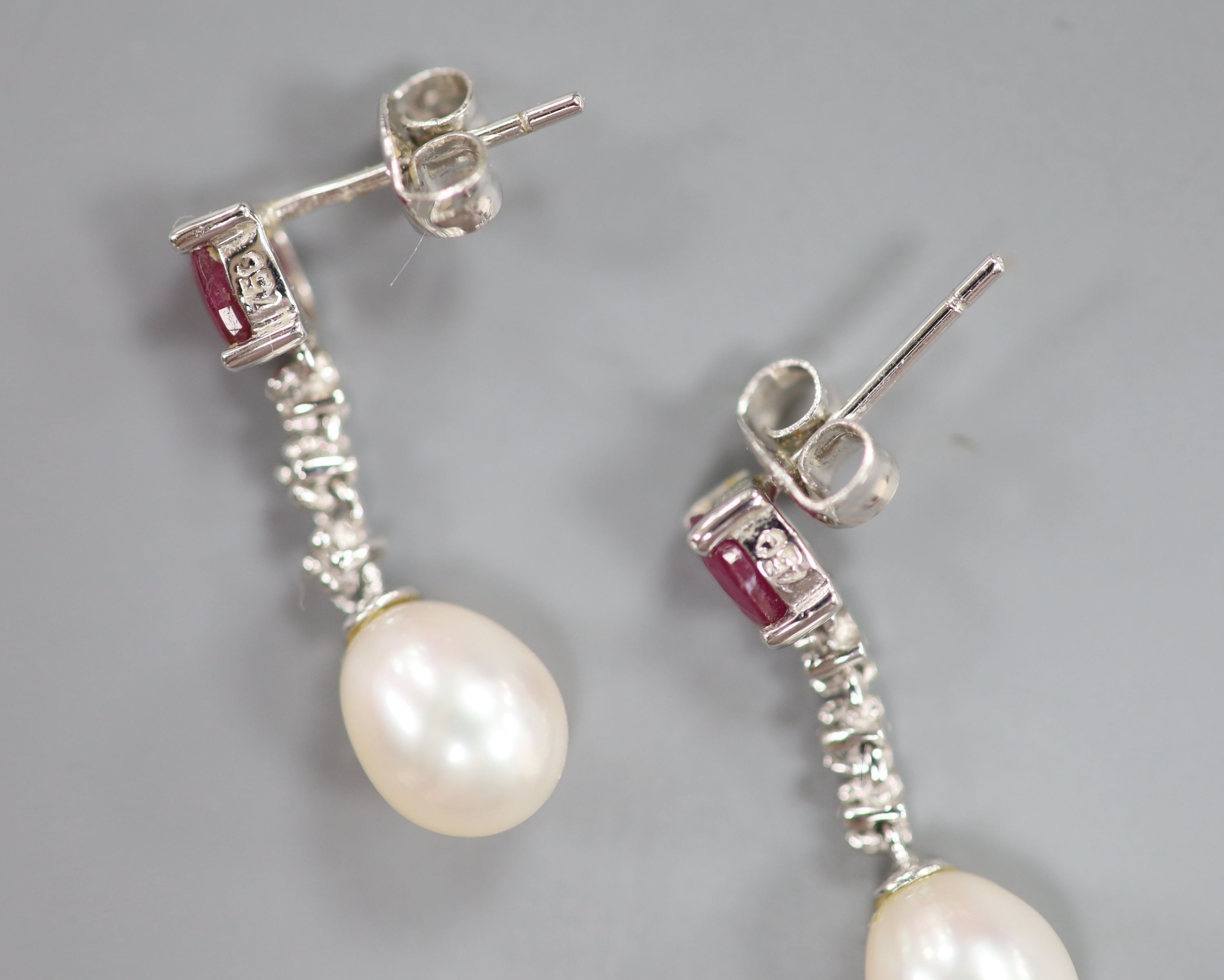 A modern pair of 750 white metal, ruby, diamond chip and cultured pearl set drop earrings, 22mm, gross 2.9 grams.